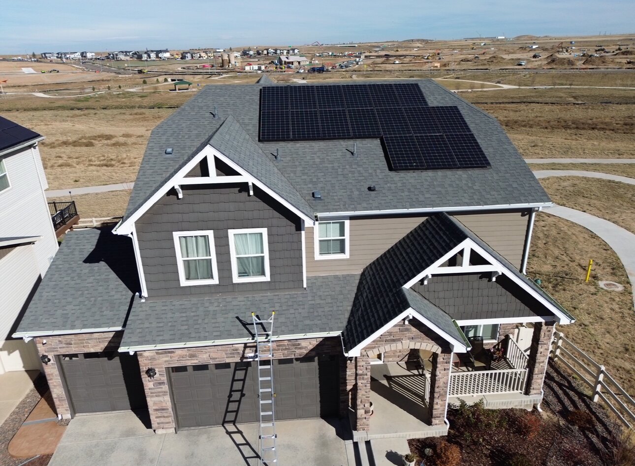 Roofco-installed solar panel array on a Denver-area home with new asphalt shingle roof