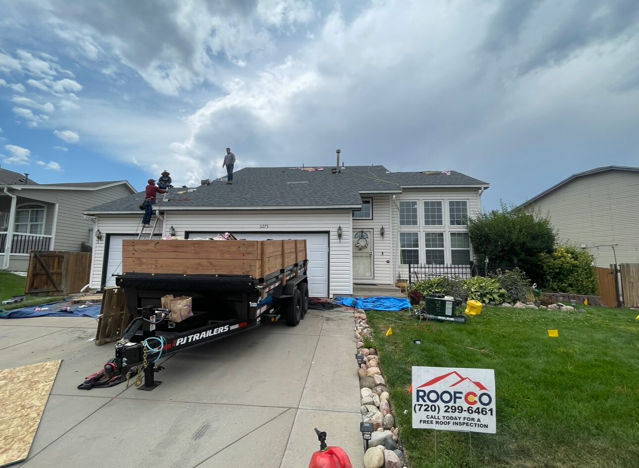 Roofco trailer with materials on driveway, Denver